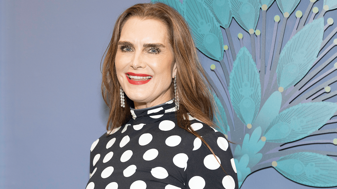 Brooke Shields wearing a polka dot top, and red lipstick.