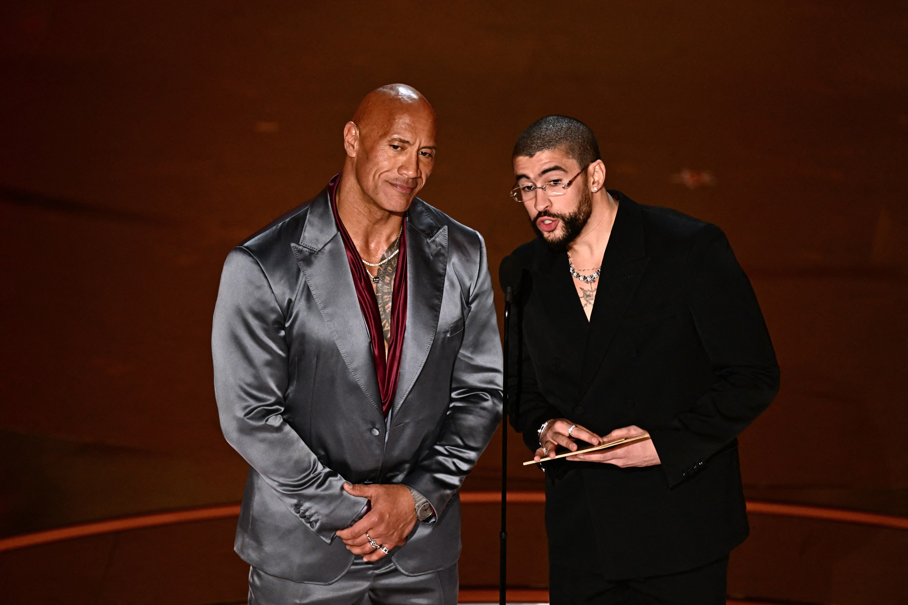 US actor Dwayne Johnson (L) and Puerto Rican singer Bad Bunny present the award for Best International Feature Film onstage during the 96th Annual Academy Awards at the Dolby Theatre in Hollywood, California on March 10, 2024.