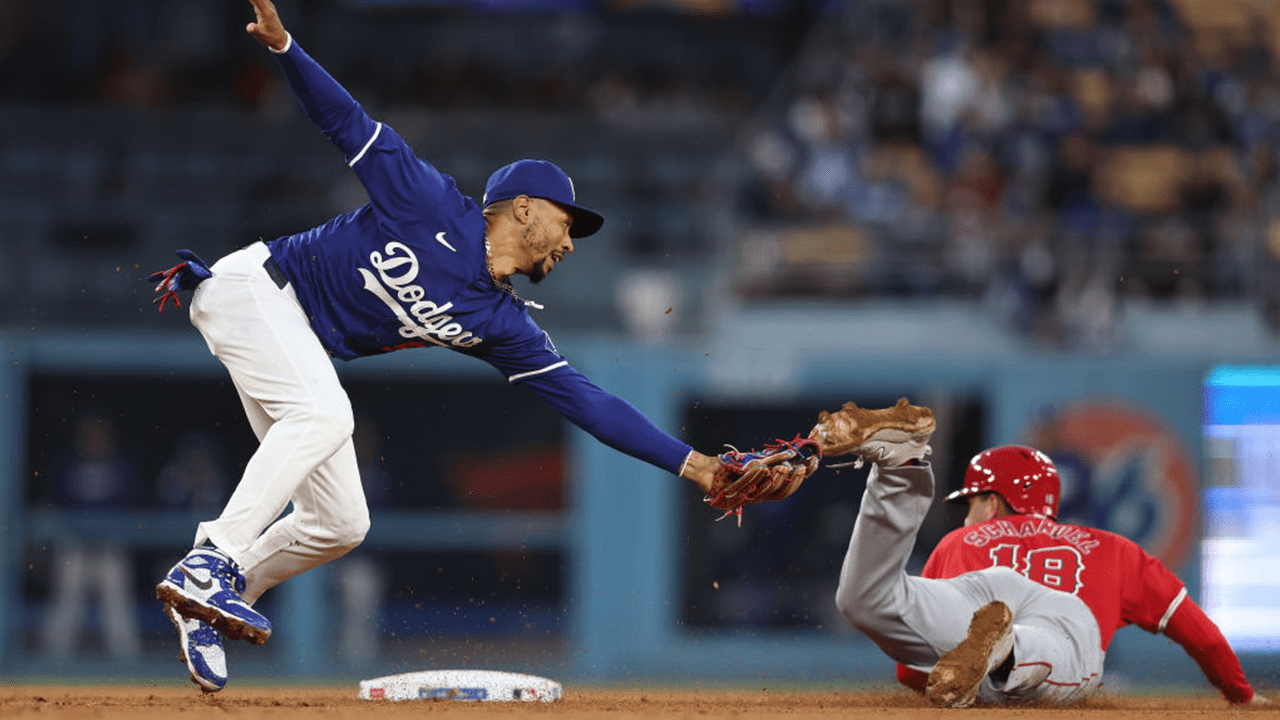 Mookie Betts #50 of the Los Angeles Dodgers goes for the tag as Nolan Schanuel #18 of the Los Angeles Angels slides into second base safely during the fourth inning at Dodger Stadium on March 25, 2024 in Los Angeles, California.