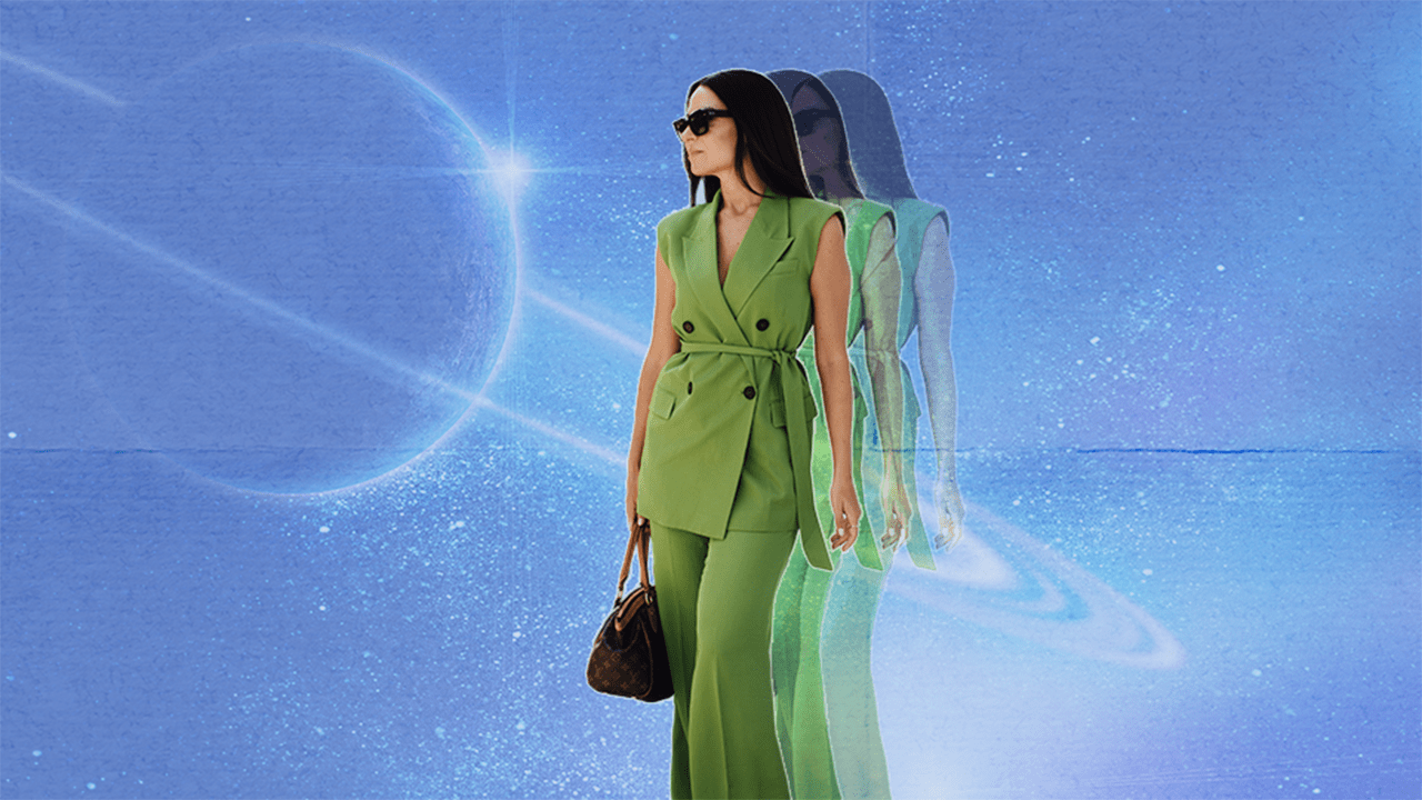 A woman wearing a green suit standing in front of planet Saturn with a bluish sky background