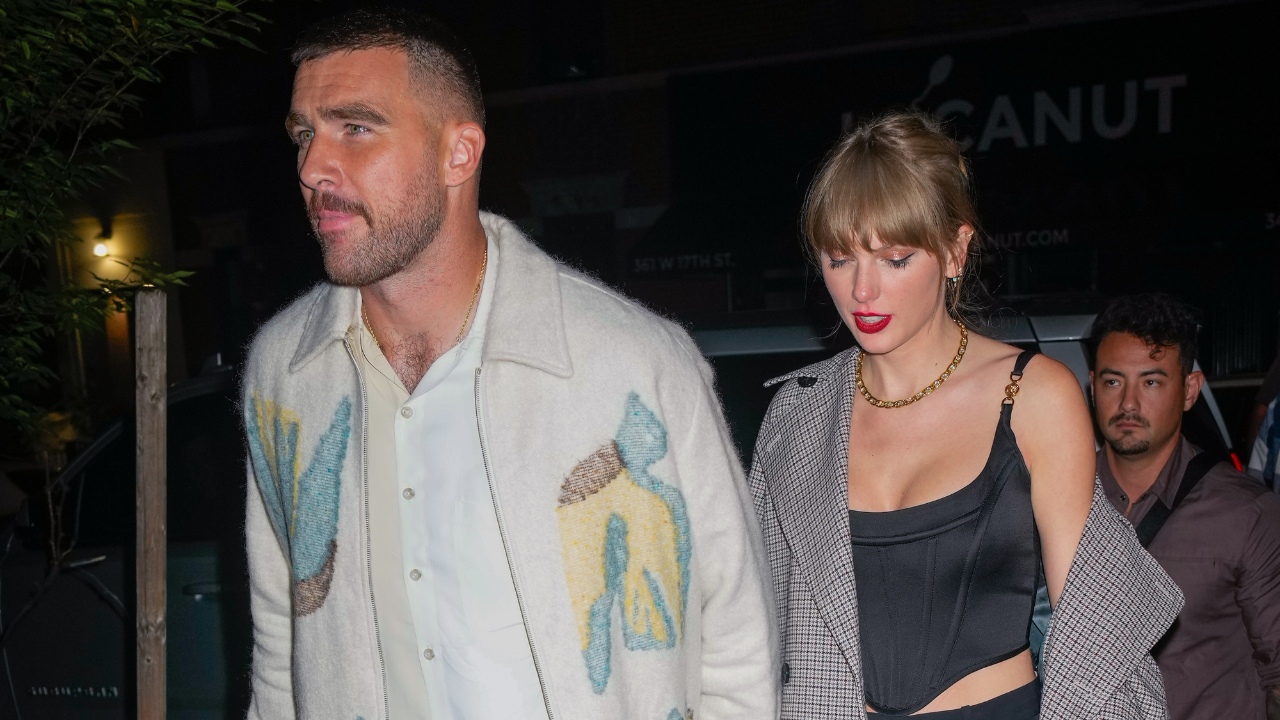 Image of Travis Kelce holding hands with girlfriend Taylor Swift while out on a date.